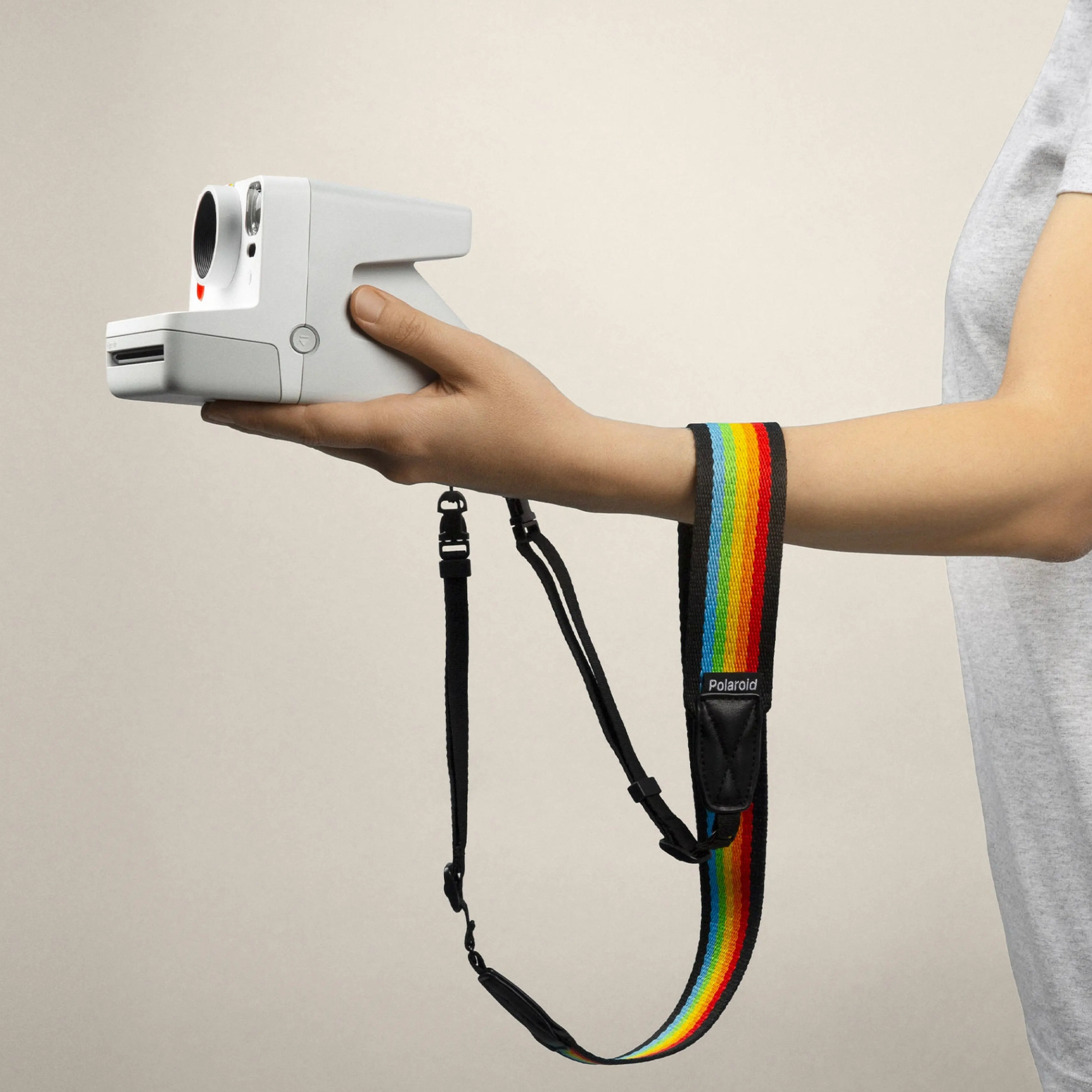 CAMERA STRAP FLAT WHITE/BLACK Camera strap - flat by Polaroid An effortless accessory for Polaroid Now+, Now, OneStep+ and OneStep 2 cameras. Featuring Polaroid branding and a no-snag plastic release, grab this wide and flat camera strap for more hands-off moments.Flat camera strap with plastic release. Color: Rainbow Black / Rainbow White Fits Polaroid Now+, Now, OneStep 2 and OneStep+ cameras. Adjustable, one size fits all. Length: 43 in (110cm) Width: 1.4 in (3.5 cm)